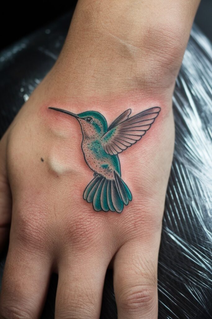 Vibrant Hummingbird Hand Tattoo