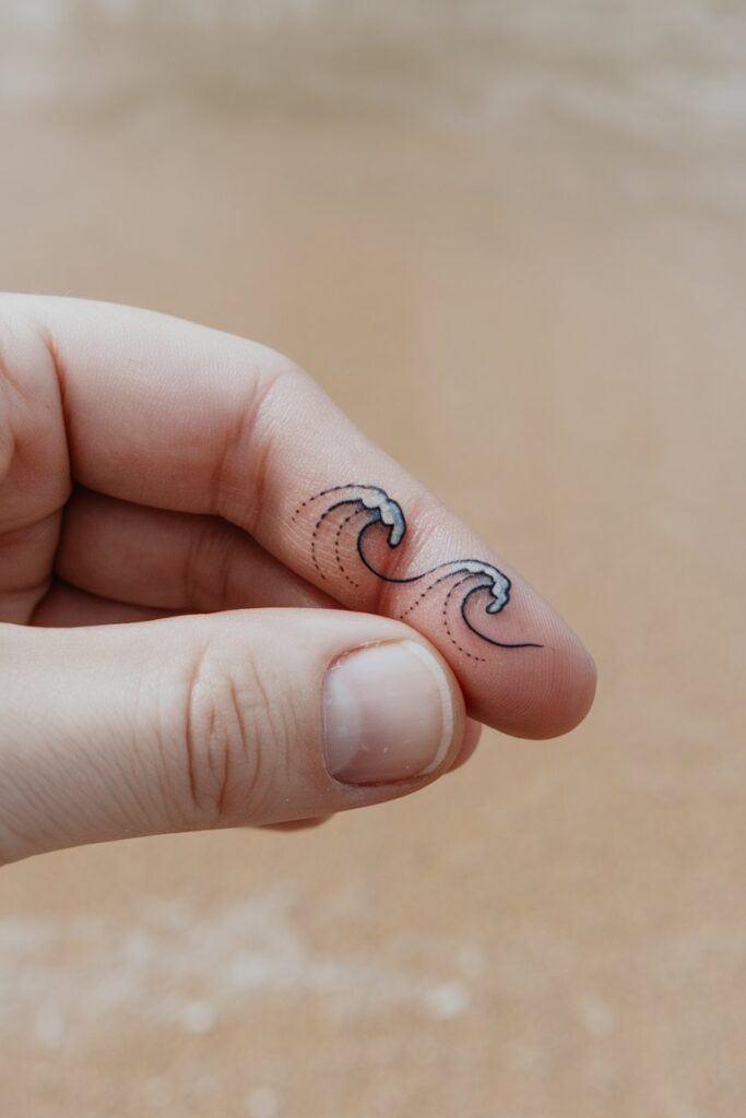 Tiny Wave Tattoos on the Finger