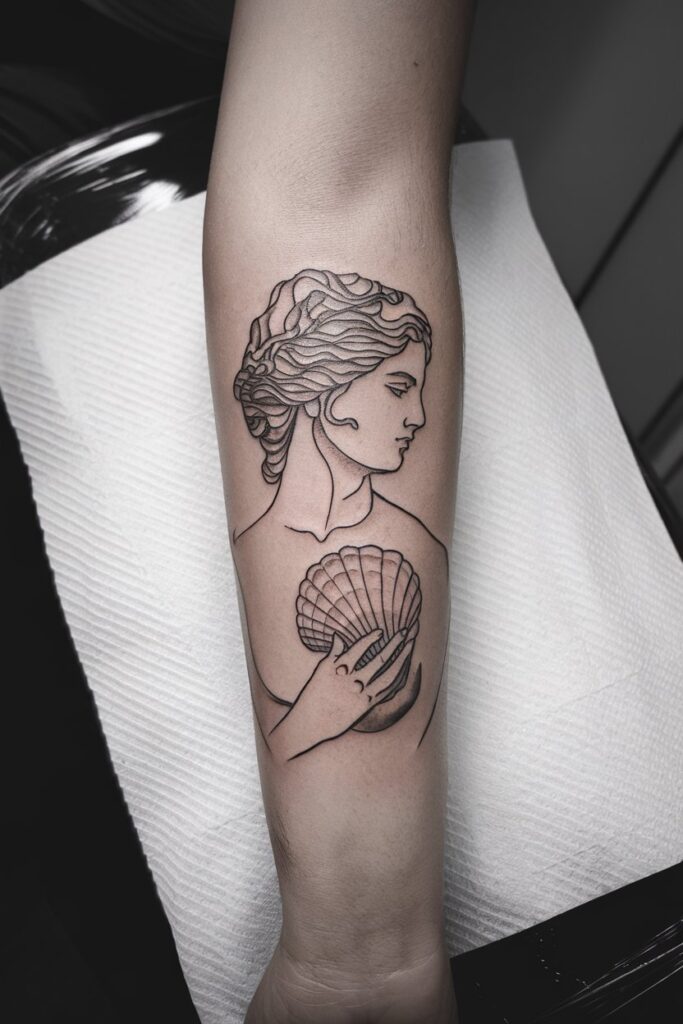 15. Shell Holding Goddess Forearm Tattoo